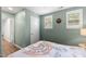 Bright bedroom boasts green walls, two windows, and a gracefully decorated, inviting bed at 404 Blooming Meadows Rd, Holly Springs, NC 27540