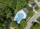 Aerial view of the community pool surrounded by trees, creating a refreshing and inviting space at 404 Blooming Meadows Rd, Holly Springs, NC 27540