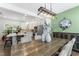 Dining area featuring a rustic wood table, stylish light fixture, and accent wall, perfect for Gathering meals and gatherings at 404 Blooming Meadows Rd, Holly Springs, NC 27540