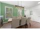 Bright dining room with wood table, contemporary lighting, and shuttered windows at 404 Blooming Meadows Rd, Holly Springs, NC 27540