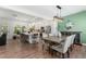 Open-concept kitchen with a large island, stainless steel appliances, and an adjacent dining area with wood floors at 404 Blooming Meadows Rd, Holly Springs, NC 27540