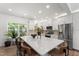 Spacious kitchen featuring a large island with seating, stainless steel appliances, and bright, white cabinetry at 404 Blooming Meadows Rd, Holly Springs, NC 27540