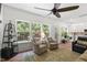 Bright sunroom with armchairs, rug, and multiple windows offering lots of natural light at 404 Blooming Meadows Rd, Holly Springs, NC 27540