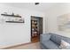 Cozy living room featuring stylish shelves and a glimpse into a wallpapered nook at 404 Blooming Meadows Rd, Holly Springs, NC 27540