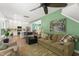 Open-concept living room with modern furnishings and an adjacent kitchen space, great for entertaining at 404 Blooming Meadows Rd, Holly Springs, NC 27540