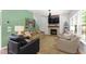 Cozy living room with fireplace, ceiling fan, comfortable seating, and bright windows at 404 Blooming Meadows Rd, Holly Springs, NC 27540