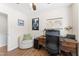 Bright office features wooden desk, comfortable seating, and a view, promoting productivity at 404 Blooming Meadows Rd, Holly Springs, NC 27540