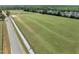 Expansive grassy field bordered by a walking trail, perfect for outdoor activities and recreation at 404 Blooming Meadows Rd, Holly Springs, NC 27540