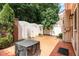 The back patio includes red stamped concrete, privacy fences, landscaping, and some patio furniture at 4060 Barton Park Pl, Raleigh, NC 27613