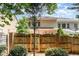 View of backyard featuring a wood fence with brick pillars and mature trees at 4060 Barton Park Pl, Raleigh, NC 27613