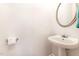 Cozy half bath featuring a pedestal sink, round mirror, and modern fixtures at 4060 Barton Park Pl, Raleigh, NC 27613