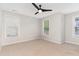 Bright bedroom with dual windows, neutral carpet, and a ceiling fan for added comfort at 4060 Barton Park Pl, Raleigh, NC 27613