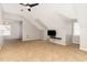 A neutral-toned bonus room features carpet, a ceiling fan, a mounted TV, and dormer windows at 4060 Barton Park Pl, Raleigh, NC 27613
