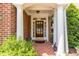 Welcoming front entrance with brick columns, a glass-paneled door, and manicured landscaping at 4060 Barton Park Pl, Raleigh, NC 27613