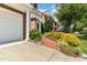 Charming brick townhome with a two-car garage, walkway, and vibrant landscaping at 4060 Barton Park Pl, Raleigh, NC 27613