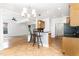 Open-concept kitchen featuring a breakfast bar and seamless flow into the adjacent living space at 4060 Barton Park Pl, Raleigh, NC 27613