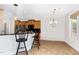 Charming kitchen featuring wood cabinets, a black countertop, and bar stool seating at 4060 Barton Park Pl, Raleigh, NC 27613