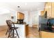 Well-equipped kitchen with wood cabinets, stainless steel appliances, and a breakfast bar area at 4060 Barton Park Pl, Raleigh, NC 27613