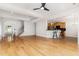 Elegant living room with hardwood floors that flows into a modern kitchen and staircase at 4060 Barton Park Pl, Raleigh, NC 27613