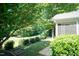 Scenic backyard view with mature landscaping, a neatly manicured lawn, and a view of the screened porch at 418 Byrams Ford Dr, Cary, NC 27513