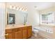 Bathroom with double vanity, large mirror, bathtub, and a separate glass shower at 418 Byrams Ford Dr, Cary, NC 27513