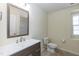 Bathroom features a modern vanity, brushed nickel faucet, and a framed mirror at 418 Byrams Ford Dr, Cary, NC 27513