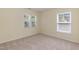 Bedroom with neutral carpet and walls featuring natural light from two windows at 418 Byrams Ford Dr, Cary, NC 27513