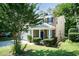 Charming two-story home featuring blue shutters, stone accents, a well-manicured lawn, and lush landscaping at 418 Byrams Ford Dr, Cary, NC 27513