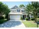 Charming two-story home with a well-maintained yard, a two-car garage, and an inviting entrance at 418 Byrams Ford Dr, Cary, NC 27513