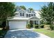 Attractive two-story house with a two-car garage, manicured lawn, and a welcoming front entrance at 418 Byrams Ford Dr, Cary, NC 27513
