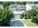 Two-story home with blue shutters, stone accents, a lush front lawn, and a two car garage at 418 Byrams Ford Dr, Cary, NC 27513