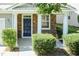Inviting front porch featuring stone accents, white columns, and a vibrant blue front door at 418 Byrams Ford Dr, Cary, NC 27513