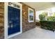 Close-up of a front porch showing the stone facade, a blue front door, and manicured shrubbery at 418 Byrams Ford Dr, Cary, NC 27513