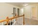 Upstairs hallway with neutral carpet and trim, leading to multiple rooms with paneled doors at 418 Byrams Ford Dr, Cary, NC 27513