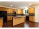 Bright kitchen features wood cabinets, a center island, tile backsplash, and stainless appliances at 418 Byrams Ford Dr, Cary, NC 27513