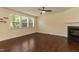 Spacious living room showcasing hardwood floors, a ceiling fan, and a cozy fireplace at 418 Byrams Ford Dr, Cary, NC 27513