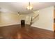 Open floor plan living area with hardwood floors and a fireplace, leading to staircase at 418 Byrams Ford Dr, Cary, NC 27513