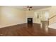 Open living area featuring hardwood floors, a fireplace, and a view to an open staircase at 418 Byrams Ford Dr, Cary, NC 27513