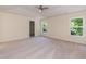 Bright main bedroom featuring a tray ceiling, walk-in closet, carpet, and two windows at 418 Byrams Ford Dr, Cary, NC 27513