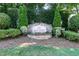 Community entrance sign for 'The Battery' with stone accents, flowers, and mature landscaping at 418 Byrams Ford Dr, Cary, NC 27513
