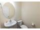 Clean and simple powder room with pedestal sink, toilet, and neutral wall color at 418 Byrams Ford Dr, Cary, NC 27513