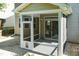 An exterior view of a screened-in porch with a pet door and access to the backyard at 418 Byrams Ford Dr, Cary, NC 27513