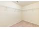Walk-in closet with neutral walls and carpet featuring wire shelving units at 418 Byrams Ford Dr, Cary, NC 27513