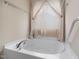 Bathroom showcasing a large soaking tub next to a window with light filtering in at 4205 Twin Spires Dr, Knightdale, NC 27545