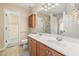 Bathroom featuring double sink vanity, tiled floors, and shower at 4205 Twin Spires Dr, Knightdale, NC 27545