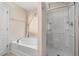 Bright bathroom showcasing a separate tub and shower with tile surround and glass door at 4205 Twin Spires Dr, Knightdale, NC 27545