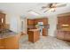 Well-lit kitchen with an island, wooden cabinets, and modern appliances at 4205 Twin Spires Dr, Knightdale, NC 27545