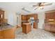 Spacious kitchen featuring an island, tile floors, wooden cabinets, and modern appliances at 4205 Twin Spires Dr, Knightdale, NC 27545