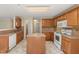 Bright kitchen featuring an island, ample counter space, and white appliances at 4205 Twin Spires Dr, Knightdale, NC 27545