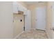 Practical laundry room with storage cabinets and tile floors near exterior door at 4205 Twin Spires Dr, Knightdale, NC 27545